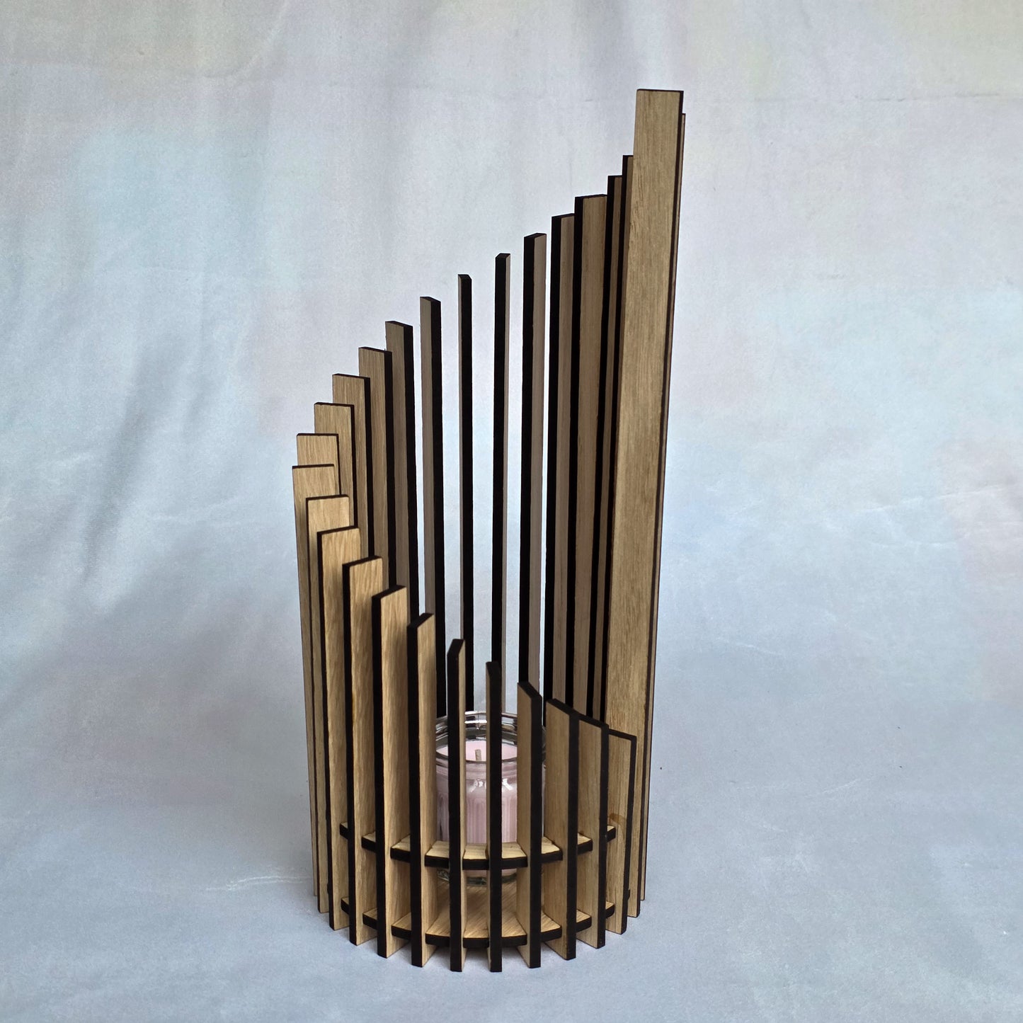 Wooden candle holder with vertical slats on a white background
