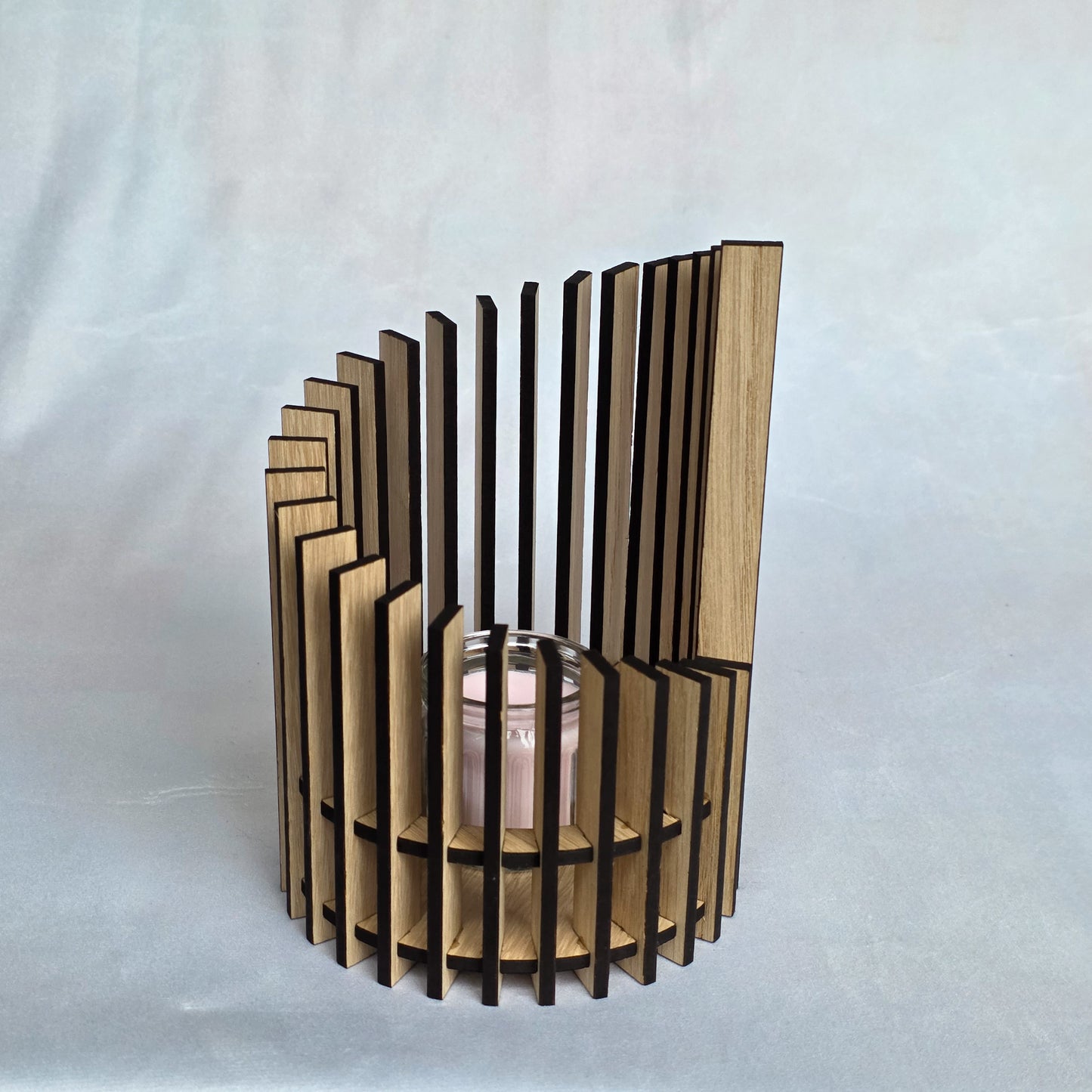 Wooden candle holder with geometric design on a white background
