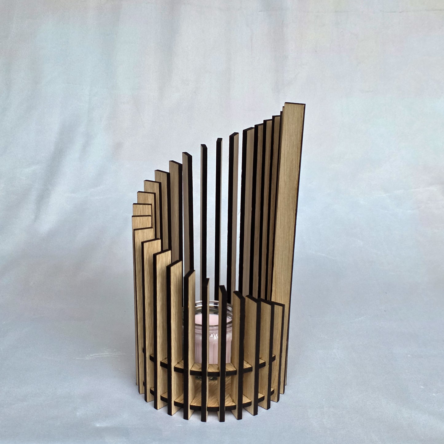 Wooden candle holder with slatted design on a white background